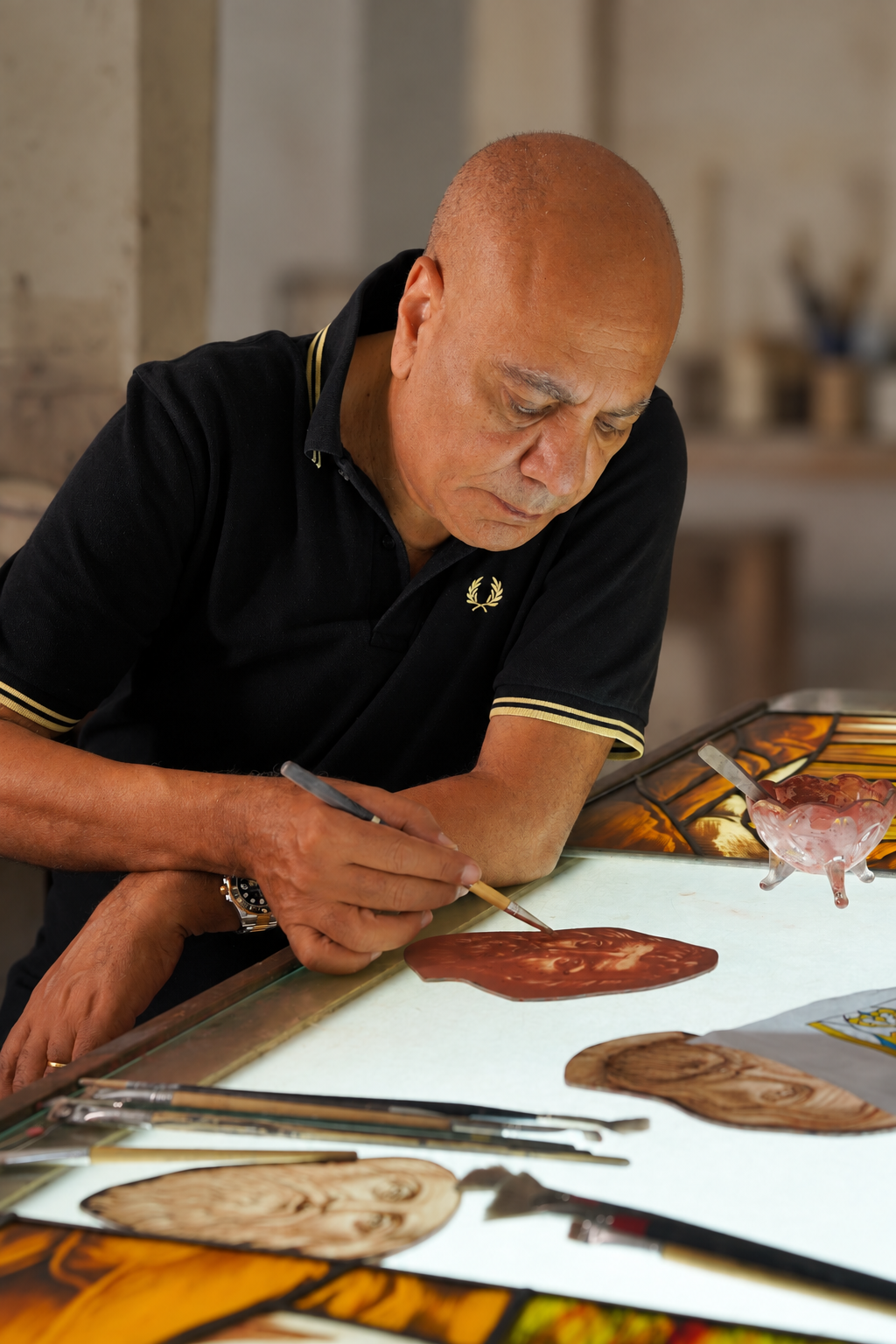 Nagui Riad hand-painting a stained glass piece